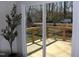 View of a new wooden deck through sliding glass doors, expanding the indoor living space at 5635 Paragon Cir, Durham, NC 27712