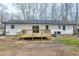 Back exterior with a wooden deck and access to a sliding glass door at 5635 Paragon Cir, Durham, NC 27712