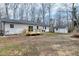 Backyard view of a home with a wooden deck, sliding glass door, and storage shed at 5635 Paragon Cir, Durham, NC 27712