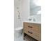 Well-lit bathroom with a modern vanity, decorative mirror, and walk-in shower at 5635 Paragon Cir, Durham, NC 27712