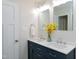Elegant bathroom featuring double vanity, quartz countertop and modern lighting at 5635 Paragon Cir, Durham, NC 27712