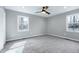 Minimalist bedroom featuring plush carpet, neutral walls, and windows for natural light at 5635 Paragon Cir, Durham, NC 27712