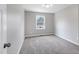 Cozy bedroom with neutral walls, soft carpeting, and a window at 5635 Paragon Cir, Durham, NC 27712