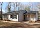 Charming single-story home featuring light siding, a dark roof, and a cozy covered front porch at 5635 Paragon Cir, Durham, NC 27712