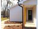Charming front entrance with a black door framed by wooden porch supports and manicured landscaping at 5635 Paragon Cir, Durham, NC 27712