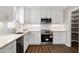 Bright kitchen featuring white cabinets, stainless steel appliances, stone countertops, and subway tile backsplash at 5635 Paragon Cir, Durham, NC 27712