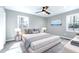 Comfortable bedroom featuring plush carpet, neutral walls, a ceiling fan, and windows for natural light at 5635 Paragon Cir, Durham, NC 27712