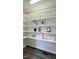Walk-in pantry featuring white shelves with various food and household items neatly arranged at 5635 Paragon Cir, Durham, NC 27712