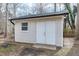 Backyard storage shed featuring double doors and a window at 5635 Paragon Cir, Durham, NC 27712
