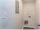 Utility room with washer hookups, electrical box, fresh white paint, and new wood-look floors at 5635 Paragon Cir, Durham, NC 27712