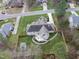 Backyard view of brick home showing deck, patio, fenced yard, and mature trees at 6 Kersey Ct, Durham, NC 27713