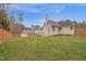 A well-maintained backyard lawn and a wooden fence, and a house with a two-story deck with stairs at 6 Kersey Ct, Durham, NC 27713