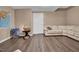 Finished basement with light wood-look flooring, featuring a cozy seating area with a white leather couch at 6 Kersey Ct, Durham, NC 27713