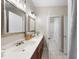 Bathroom featuring double sinks with modern fixtures, decorative mirrors, and neutral tones at 6 Kersey Ct, Durham, NC 27713