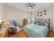 Cozy bedroom featuring hardwood floors, a ceiling fan, and comfortable seating area, perfect for relaxation at 6 Kersey Ct, Durham, NC 27713