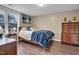 Bedroom features wood flooring, a large window, neutral wall color, and a well-made bed with matching dressers at 6 Kersey Ct, Durham, NC 27713