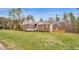 A brick and siding home is set back on a sprawling lawn, providing a peaceful setting at 6 Kersey Ct, Durham, NC 27713
