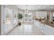 Eat-in kitchen featuring a breakfast bar, tiled floors, chandelier, and large windows for ample natural light at 6 Kersey Ct, Durham, NC 27713