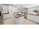 Bright kitchen featuring white cabinetry, an island cooktop, stainless steel appliances, and tile flooring at 6 Kersey Ct, Durham, NC 27713