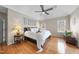 Serene bedroom with hardwood floors, ceiling fan, and an abundance of natural light through multiple windows at 6 Kersey Ct, Durham, NC 27713