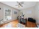 Well-lit home office with hardwood floors, a ceiling fan, and a functional desk setup for productivity at 6 Kersey Ct, Durham, NC 27713