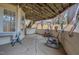 A covered patio with string lights, grey rocking chairs, and a stone floor, great for outdoor entertaining at 6 Kersey Ct, Durham, NC 27713