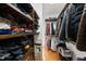 Organized walk-in closet with wooden shelving and rods, maximizing storage space for clothing and accessories at 6 Kersey Ct, Durham, NC 27713
