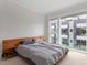 This bedroom features a modern platform bed and large window views at 712 E Edenton St # 102, Raleigh, NC 27601