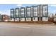 Modern townhomes feature sleek lines, large windows, and neutral color palette, with professionally landscaped front yards at 712 E Edenton St # 102, Raleigh, NC 27601