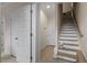Hallway featuring a staircase, wooden floors and trim, and multiple white paneled doors at 712 E Edenton St # 102, Raleigh, NC 27601
