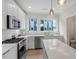 Modern kitchen featuring white cabinets, stainless steel appliances, quartz countertops and great natural light at 712 E Edenton St # 102, Raleigh, NC 27601