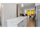 Modern kitchen with white cabinets, stainless steel appliances, quartz countertops, island and access to dining area at 712 E Edenton St # 102, Raleigh, NC 27601