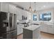 Modern kitchen featuring white cabinets, stainless steel appliances, quartz countertops and a center island at 712 E Edenton St # 102, Raleigh, NC 27601