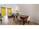 Bright living room features hardwood floors, large windows with yellow drapes, and comfortable seating area at 712 E Edenton St # 102, Raleigh, NC 27601