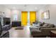 Bright living room with hardwood floors, a modern ceiling fan, and a large sectional sofa at 712 E Edenton St # 102, Raleigh, NC 27601