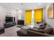 Bright living room with hardwood floors, a modern ceiling fan, and a large sectional sofa at 712 E Edenton St # 102, Raleigh, NC 27601