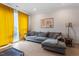 Comfortable living room features large windows with yellow drapes, hardwood floors, and comfortable seating area at 712 E Edenton St # 102, Raleigh, NC 27601