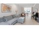 Bright living room features hardwood floors, comfortable seating, and a view into the modern kitchen at 712 E Edenton St # 102, Raleigh, NC 27601