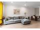 Comfortable living room features large windows with yellow drapes, hardwood floors, and view of dining area at 712 E Edenton St # 102, Raleigh, NC 27601