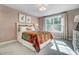 Bright bedroom featuring a comfortable bed with colorful accents and a sunlit window at 7128 Trappers Ct, Zebulon, NC 27597