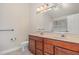 Bathroom featuring a double sink vanity, tiled floor, and ample mirror space at 9510 Dellbrook Ct, Raleigh, NC 27617