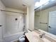 Bathroom with shower-tub combo, single sink, and standard size mirror at 9510 Dellbrook Ct, Raleigh, NC 27617