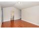 Wood-floored bedroom with an en suite bathroom, neutral walls and lots of sunlight at 9510 Dellbrook Ct, Raleigh, NC 27617
