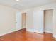 Cozy bedroom boasts hardwood floors, closet space, and neutral walls, creating a warm, inviting atmosphere at 9510 Dellbrook Ct, Raleigh, NC 27617