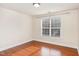 Bright bedroom features hardwood floors and a large window that lets in plenty of natural light at 9510 Dellbrook Ct, Raleigh, NC 27617