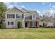 Charming two-story home with a well-manicured lawn, classic architecture, and dark shutters at 9510 Dellbrook Ct, Raleigh, NC 27617