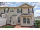 Charming two-story townhouse with neutral siding, black shutters, and neat landscaping at 9510 Dellbrook Ct, Raleigh, NC 27617