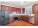 Gourmet kitchen with granite countertops, stainless steel appliances, and cherry cabinets at 9510 Dellbrook Ct, Raleigh, NC 27617