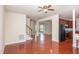 Open-concept living room with hardwood floors leading to staircase, kitchen, and front entrance at 9510 Dellbrook Ct, Raleigh, NC 27617
