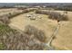 Expansive acreage featuring outbuildings, a quaint home, and a winding driveway at 9550 Silk Hope Liberty Rd, Siler City, NC 27344